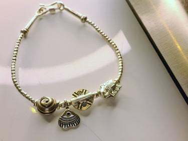 Handcrafted Silver Charm Bracelet with Yellow Gold Accents